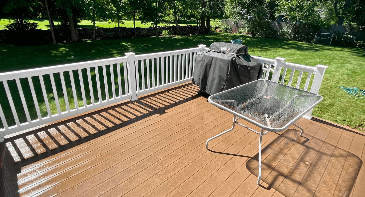 Clean restored wooden deck with natural wood color revealed after professional pressure washing and deck cleaning service in Rhode Island
